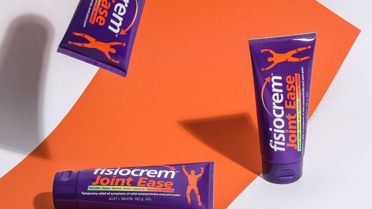 Three fisiocrem Joint Ease joint pain relief cream tubes arranged on an orange and white background.