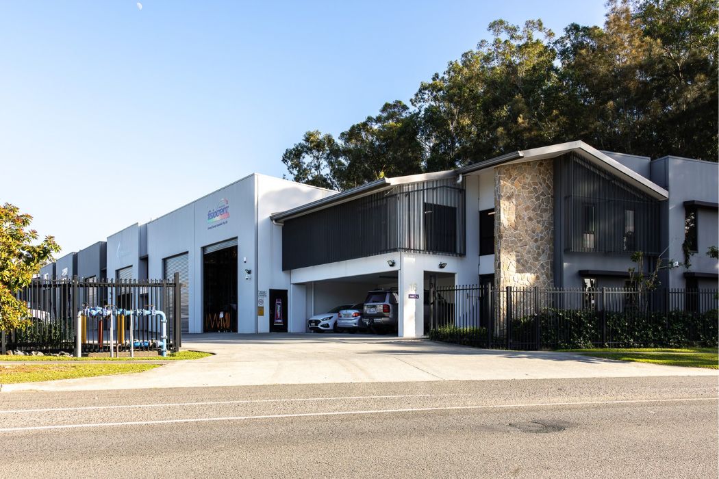Exterior of a manufacturing facility with loading bays and offices.