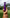Hand holding a purple fisiospray nerve pain relief spray bottle upright against a grassy park background.